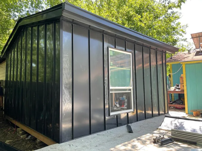 Black standing seam metal wall panels for Roof Inspection in Oak Island
