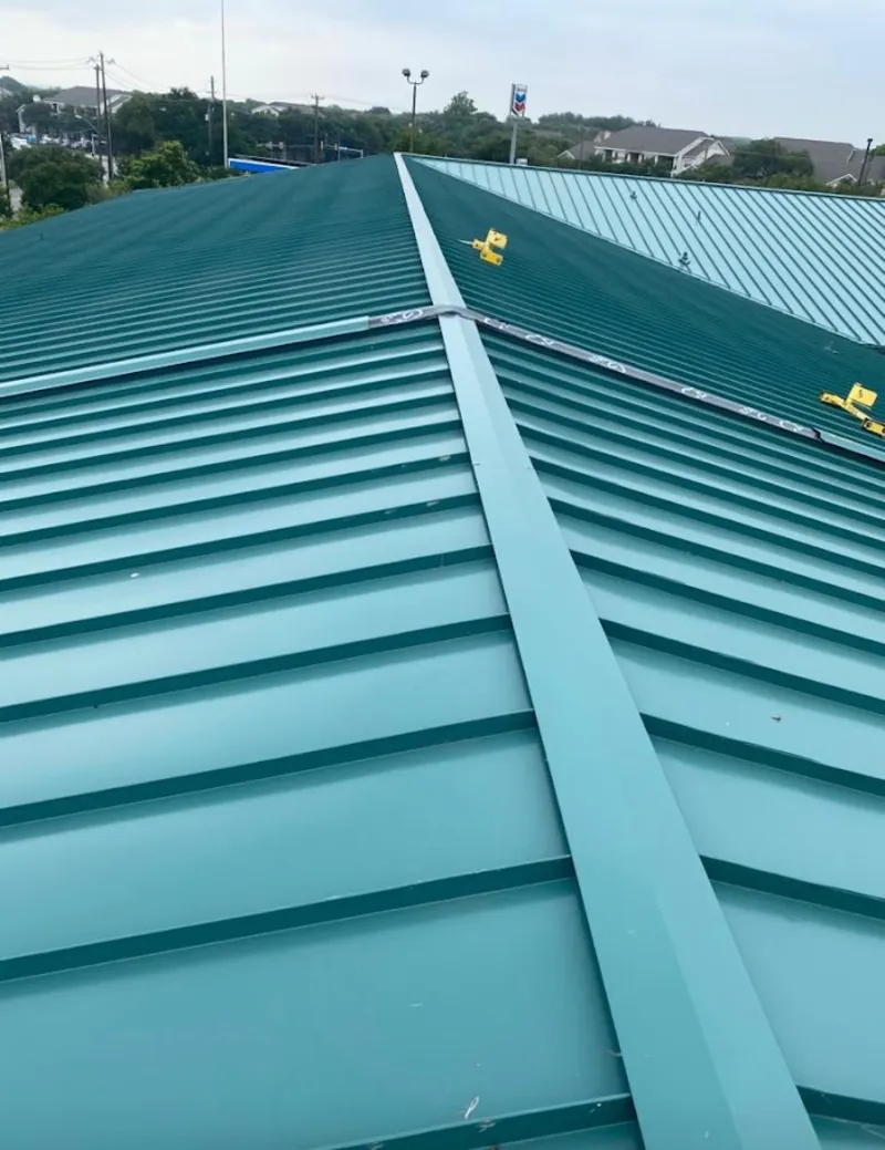 Green commercial metal roof ridge and valley for Metal Roof Repair in Oak Island